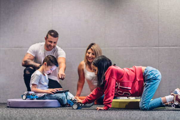 A family working together during the Robots and Coding workshop at Scienceworks.