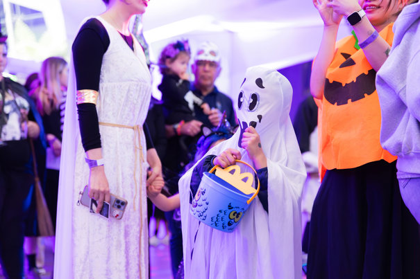 A child dressed as a ghost trick or treating during Halloween at the Museum.