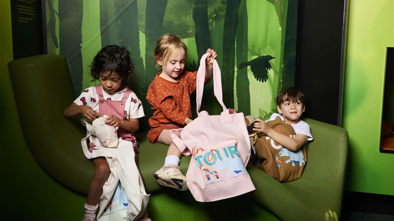 Children carrying Tiny Tours bags.
