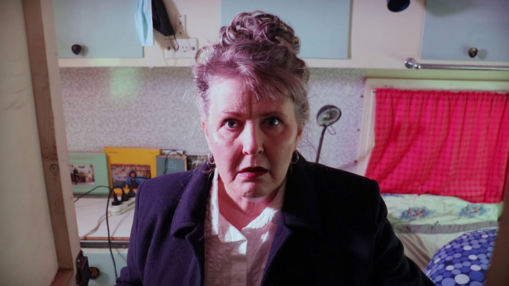 A person stares directly at the camera with an apprehensive look on their face.