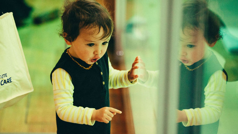 Child pointing at a museum display.