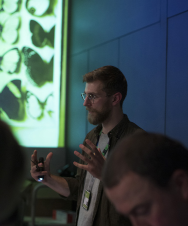 A museum staff member talks to visitors at Melbourne Museum.