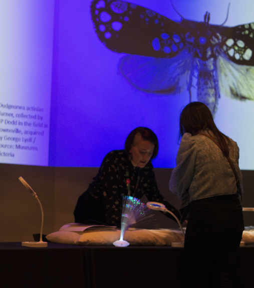 A museum staff member talks with a visitor at Melbourne Museum.