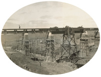 Scaffolding surrounds the brick-clad piers of the bridge over Emu Creek on the Gheringhap to Maroona line. Erection of girders, 1912