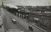 A steam locomotive hauling a passenger train, crossing Flinders Street Viaduct, circa 1910