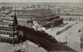 A steam locomotive hauling a passenger train, crossing Flinders Street Viaduct, circa 1910
