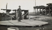 A worker standing on the base of a 24,000 gallon welded tank, Balranald, 1927. Balranald was the last station on the Moama to Balranald line.