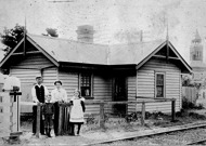Gatekeeper and family in front of their home, at a railway level crossing, Newport, circa 1905