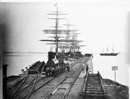 View of sailing ships berthed at Railway Pier, Williamstown, circa 1860s, with early Victorian Railways 0-6-0 type (later P class) goods locomotive in the foreground