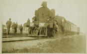 Steam locomotive D2 766 with passenger carriages attached, circa 1920