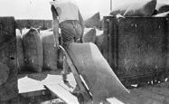Loading grain into rail trucks, Nyarrin Station, circa 1920