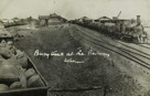 Trains carrying filled sacks passing through a railway station, circa 1910