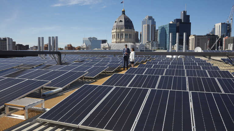 The Hon. Robin Scott, Assistant Treasurer and The Hon. Lily D'Ambrosio, Minister for Energy, Environment and Climate Change, on the Melbourne Museum roof among the 2,700 new solar panels.
