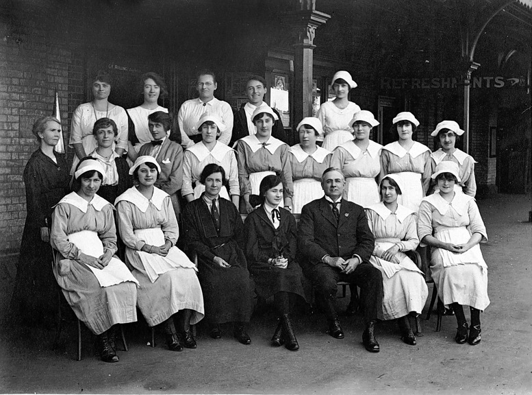A group of 21 refreshment room staff pose on the platform at Bendigo Railway Station where Mondays were a very busy morning with passenger trains arriving from Echuca, Swan Hill, Heathcote, Cohuna, Robinvale and Kulwin, circa 1929.