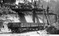 Construction staff dumping ballast into railway trucks on the Bairnsdale to Orbost line, 1914