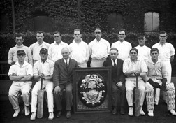 Members of the Victorian interstate railway workshop cricket team and a large, framed trophy, Newport, 1922