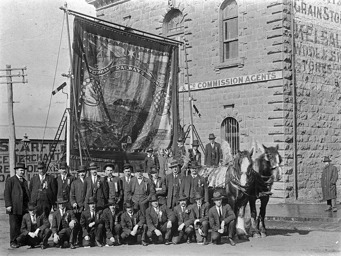 Members of the Ballarat branch of the Victorian Railways Union with their banner aloft, Ballarat, Eight Hours Day, 1913