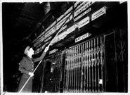 Changing the times on the Flinders Street clock, October 1945