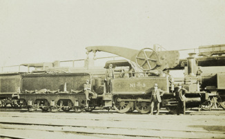 Engine no. 3 with a large crane attached to its side, circa 1910