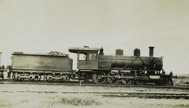Steam locomotive with a name handwritten on its side, circa 1920