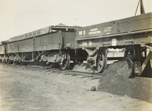 Construction of the Yarrawonga to Oaklands line, Yarrawonga, circa 1930. Ballast has been dropped from a hopper truck in the middle of the track and the ballast plough, attached to the underside of the rear rail trucks, is being spread by a v-shaped mould board.