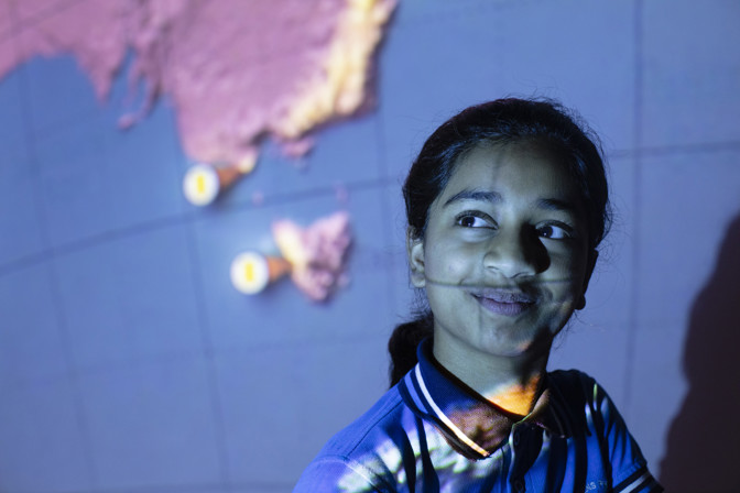 School student with light projected over their face