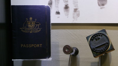Showcase displaying passport and stamp at the "Getting In" exhibition