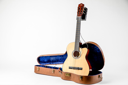 Acoustic Guitar standing up in Guitar Case with Autotuner