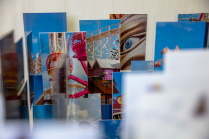 A collage of multiple hanging photographs that depict Luna Park St Kilda, Melbourne