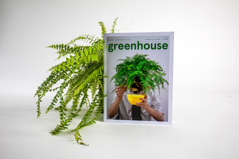 Greenhouse magazine is propped up against a pot plant