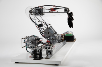 Profile view of robotic arm, made of clear acrylic, with circuit boards and electrical components visible