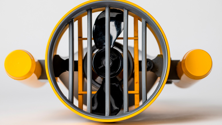 A view of a propellor from the underside. Two yellow handles sit either side of the propellor