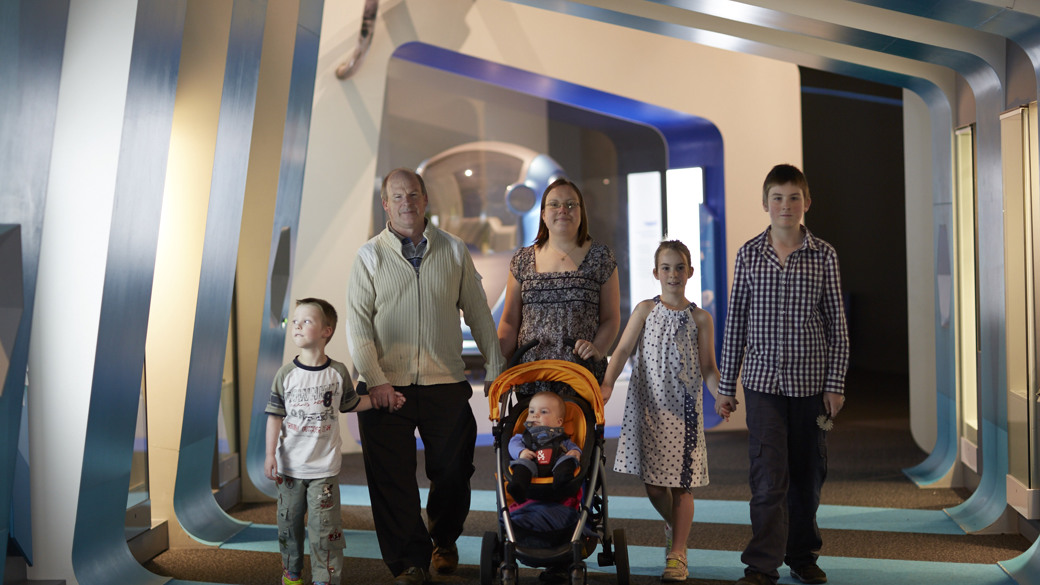 Family walking in Think Ahead exhibition