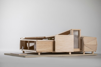 Wide shot of a the sideof miniature balsawood model of a portable classroom 