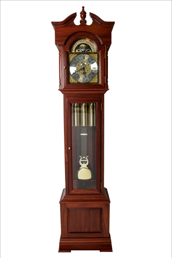 A tall wooden granfather clock with an engraved metal clock face