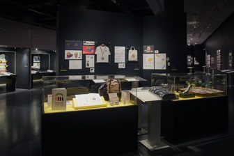 Exhibition display including wall panels and showcases