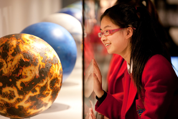 Girl looking at Earth models on display in Dynamic Earth
