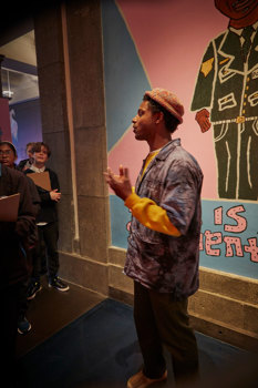 Culture Makers artist Olana Janfa giving a tour of Your Government Name for young people at the Immigration Museum.