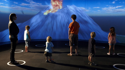 Visitors two adults and 4 children viewing 3D theatre