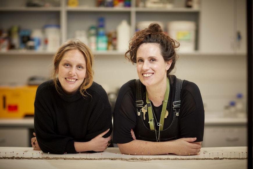 Two smiling museum staff