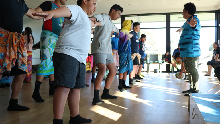 Group of boys and men rehearsing