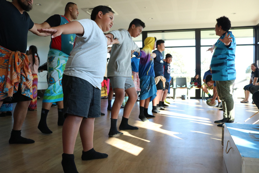 Group of boys and men rehearsing