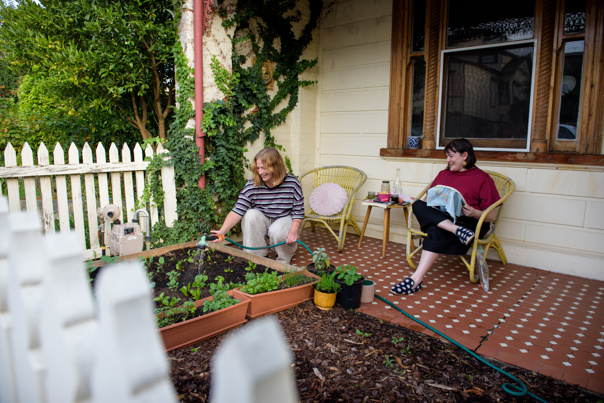Two women in front of a house