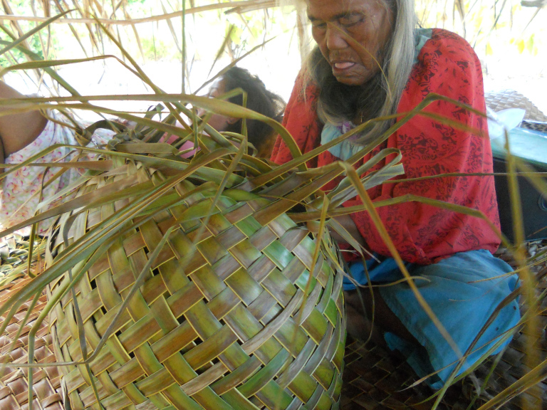 Person weaving with natural fibre