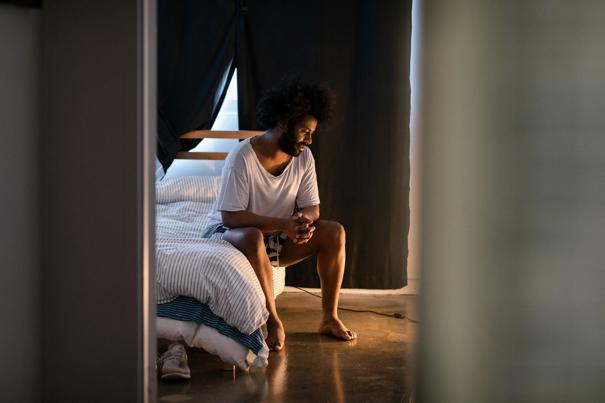Man sitting on a bed