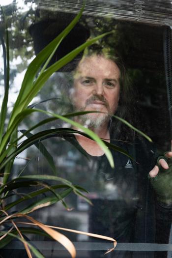 Man standing behind a window
