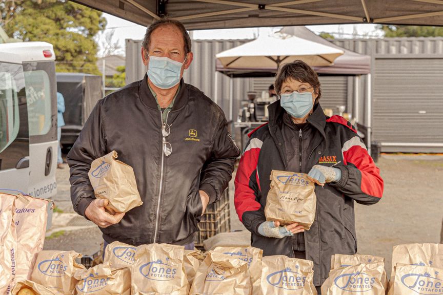 Two stall holders selling potatoes