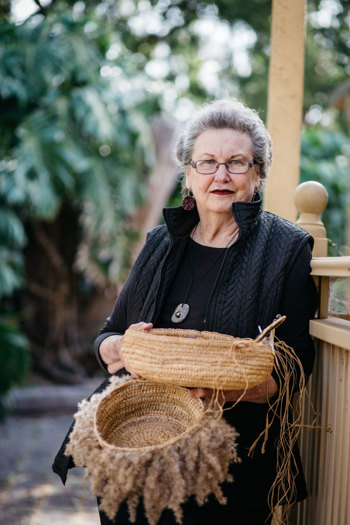 Woman holding to woven baskets