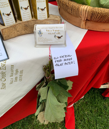A small sign displayed with a bouquet of leaves
