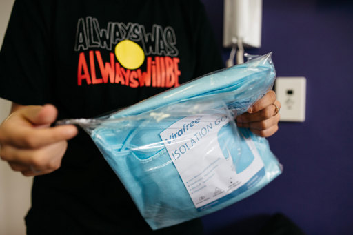 Detail of a new PPE gown being unwrapped